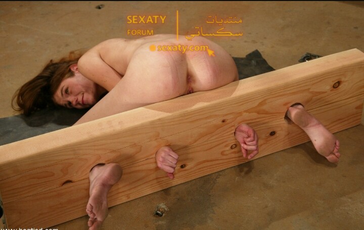 خاضعه تتعرض لضرب على فرجها من سيدها وهى مقيدة بخشب صلب